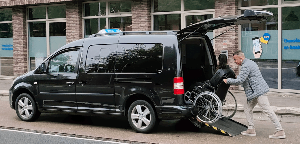 The photo shows how the driver drives the wheelchair-bound passenger into the wheelchair taxi.